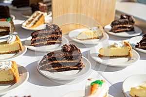 delicious chocolate cake carrot cake and key lime pie pastries on the table spread out for people to eat at an executive dinner