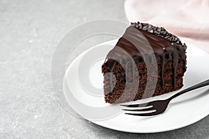 Delicious chocolate cake on grey table