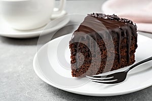 Delicious chocolate cake on light grey table