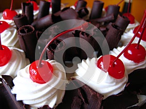 Delicious chocolate cake with maraschino cherries