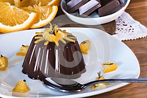 Delicious chocolate dessert with orange slices on sunrise light