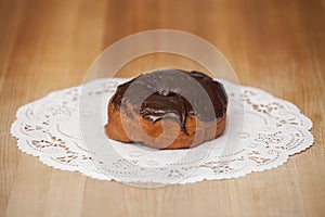 Delicious Chocolate Frosted Donut on Table