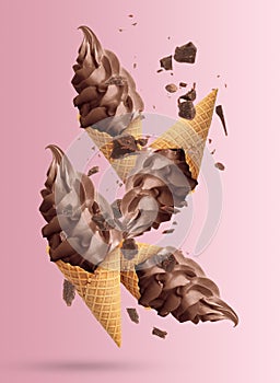 Delicious chocolate ice cream in crispy cones falling on pink
