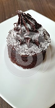 Delicious chocolate lava cake topped with chocolate cream