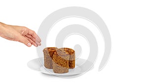 delicious chocolate with milk Swiss roll cake in hand on plate isolated on white background, home made dessert. copy space, templa