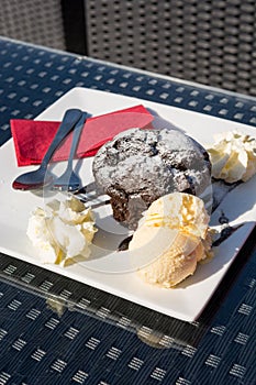 Delicious chocolate muffin served with vanilla ice cream.