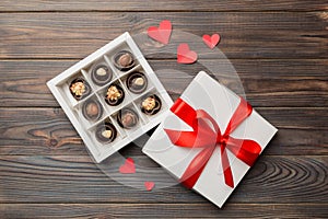 Delicious chocolate pralines in red box for Valentine's Day. Heart shaped box of chocolates top view with copy space