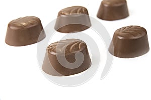 Delicious chocolate pralines on the white. Sweet candy.