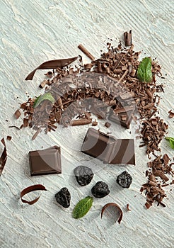 Delicious chocolate, shavings and raisins on table