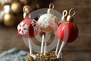 Delicious Christmas ball cake pops on background, closeup