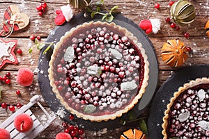 Delicious Christmas cranberry tart and festive decoration close-up. Horizontal top view