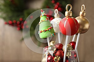 Delicious Christmas themed cake pops on blurred background. Space for text