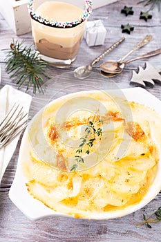 Delicious Christmas themed dinner table with potato gratin