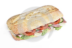 Delicious ciabatta sandwich with ham, tomatoes, fresh salad and cucumber