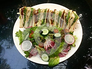 Delicious Classic Club Sandwich with fresh salad top