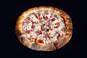 Delicious classic italian Pizza Pepperoni with sausages and cheese mozzarella. black dark background