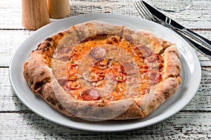 Delicious classic italian Pizza Pepperoni on a wooden table