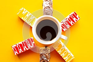 Delicious color bright cakes and coffee cup. Bright yellow background