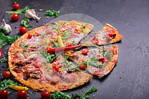 Delicious and colorful dish on a dark gray background. Traditional Italian pizza. Culinary concept. Copy space.