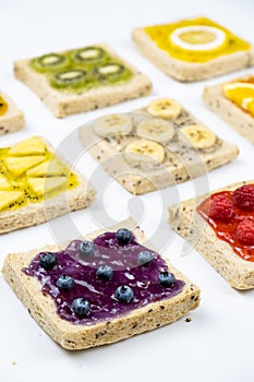 Delicious colourful minimal mix fruits jam on sliced bread. Set on white background