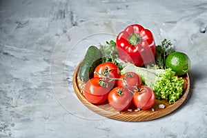 Delicious composition of assorted fresh vegetables and herbs on white textured background, top view, selective focus.