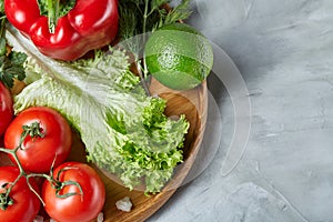 Delicious composition of assorted fresh vegetables and herbs on white textured background, top view, selective focus.