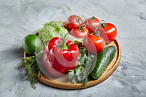 Delicious composition of assorted fresh vegetables and herbs on white textured background, top view, selective focus.