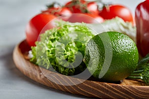 Delicious composition of assorted fresh vegetables and herbs on white textured background, top view, selective focus.