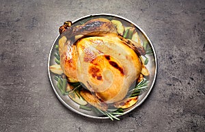 Delicious cooked turkey with garnish on grey table, top view. Thanksgiving Day celebration