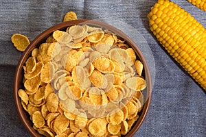 Delicious corn flakes in a bowl on the table. Top view, flat lay