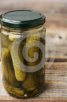 Delicious cornichons in a jar on the table
