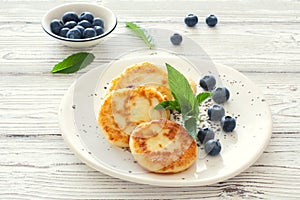 Delicious cottage cheese pancakes or syrniki with fresh blueberry