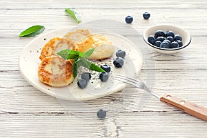 Delicious cottage cheese pancakes or syrniki with fresh blueberry