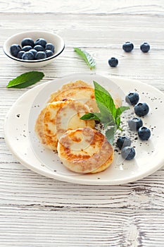 Delicious cottage cheese pancakes or syrniki with fresh blueberry