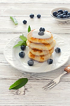 Delicious cottage cheese pancakes or syrniki with fresh blueberry