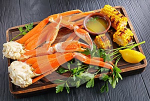 Snow Crab legs served with corn cobs photo