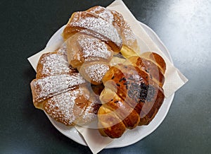 Delicious cream and chocolate croissants. View from above. Withe sugar and chocolate on top. Breakfast time