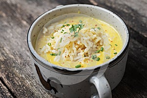 Delicious creamed squash pumpkin soup served with a scoop of rice