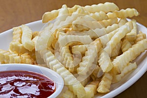 Delicious crinkle cut style french fries with ketchup