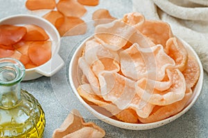 Delicious crispy chips made of starch, flour and shrimp. Bowl of Krupuk prawn crackers