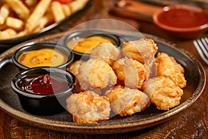 Delicious Crispy Fried Cheese Balls Served with Assorted Dips on Wooden Table, Perfect for Restaurant Menus or Food Blogs