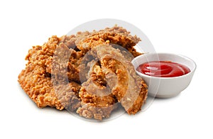 Delicious crispy fried chicken breast strips with tomato sauce isolated