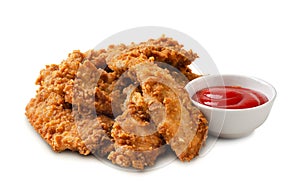 Delicious crispy fried chicken breast strips with tomato sauce isolated photo