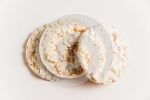 Delicious crispy puffed rice buns on a white background with copy space. Diet and healthy eating concept.