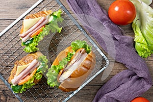 Delicious croissants sandwichs with fresh Ham, cheese, tomato, cucumber, lettuce and Sub sandwich with fresh salad, Ham , cheese.