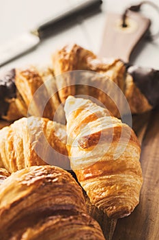 Delicious croissants on wooden board photo