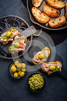 Delicious crostini with avocado spread and serrano or prosciutto ham