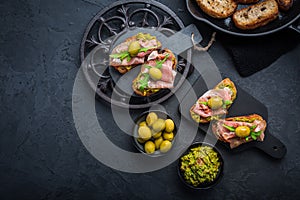 Delicious crostini with avocado spread and serrano or prosciutto ham