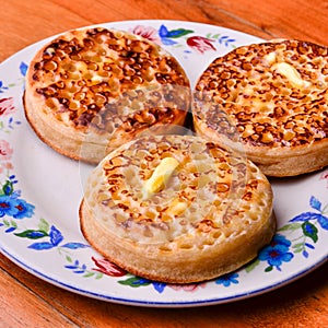 Delicious crumpets covered in melting butter