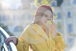 A delicious crunchy apple. Little girl biting into juicy green apple. Cute child eating apple fruit on sunny day. Small